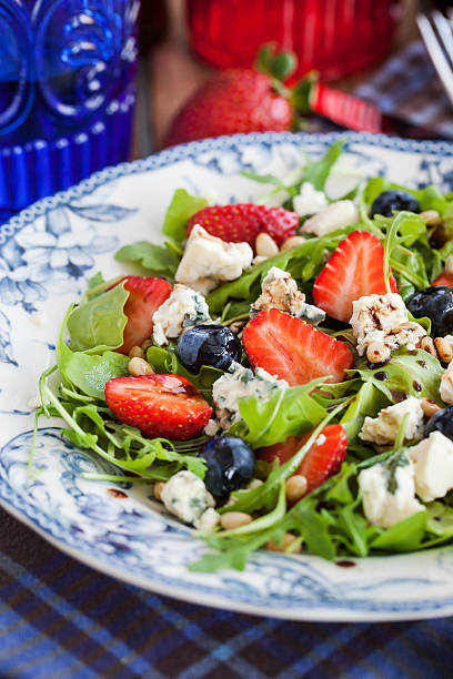 istock Arugula, strawberry, blueberry and blue cheese salad 477569866