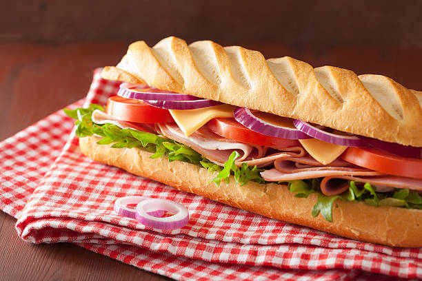 istock long baguette sandwich with ham cheese tomato lettuce 477572476