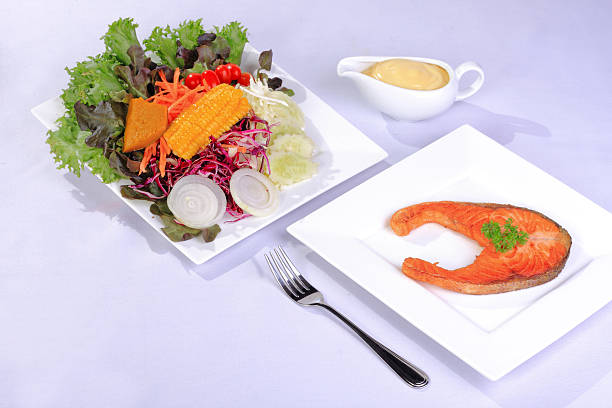 istock Salmon steak with salad 477572494