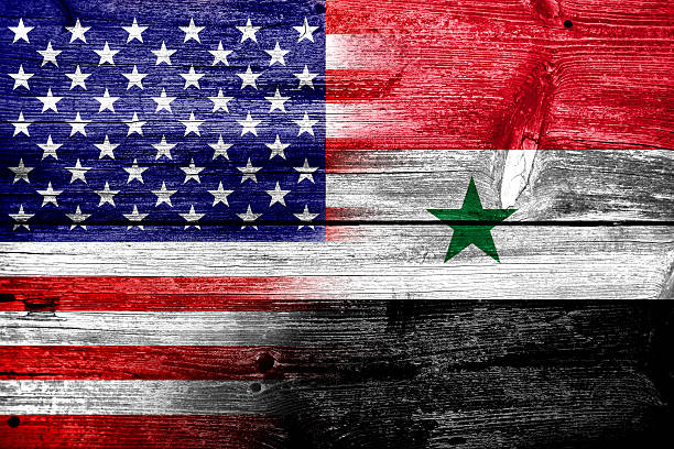 istock USA and Syria Flag painted on old wood plank texture 477576157