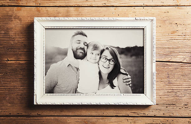 Fathers day composition Fathers day composition - picture frame with a black and white photo. Studio shot on wooden background. household equipment photos stock pictures, royalty-free photos & images