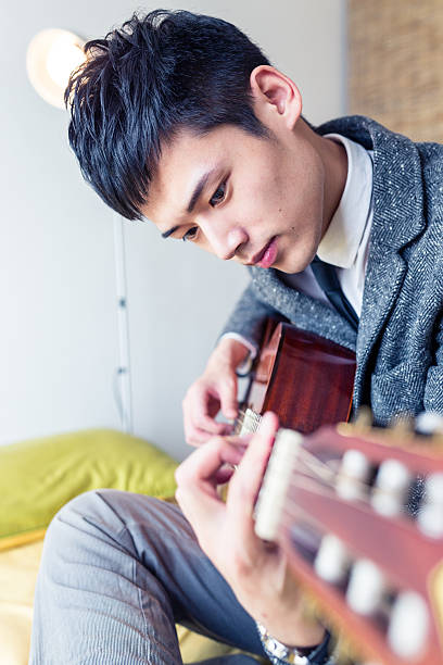 istock Boy play an acoustic guitar 477576947