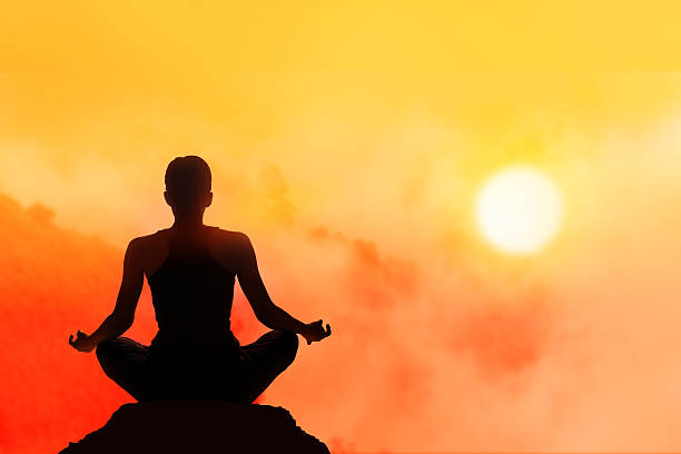 istock women meditating on high mountain in sunset background 477577300
