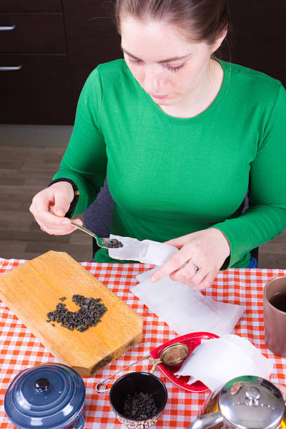 Young girl making tea in kitchen