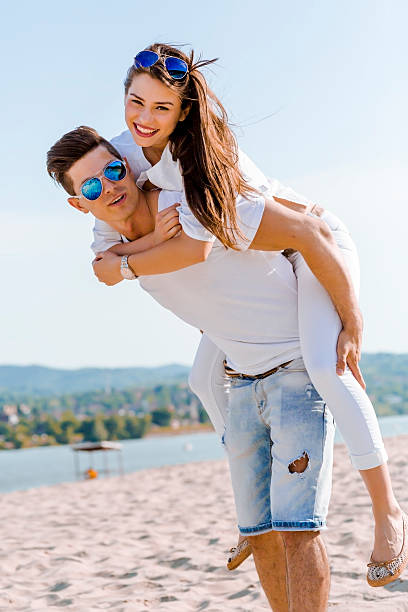 istock Cheerful handsome man carrying his girlfriend piggyback 477577368
