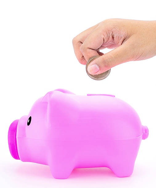 istock Putting coin into piggy bank 477577750