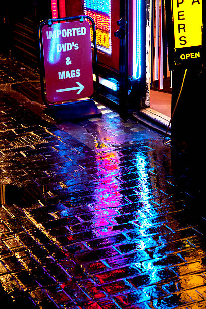 Adult book store at night Entry to an adult book shop on a wet rainy night. seedy alley stock pictures, royalty-free photos & images