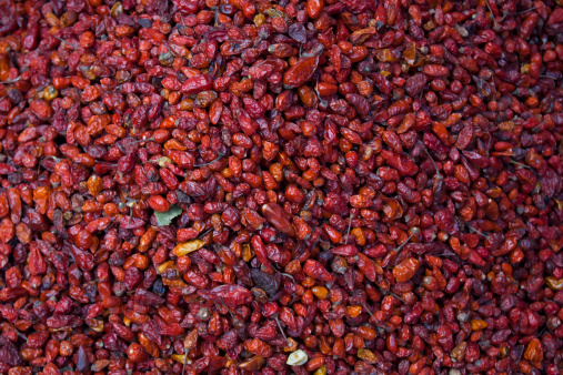 Pile of dried chiltepe peppers for sale at Chichicastenango market Guatemala