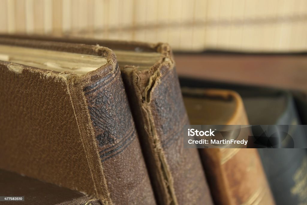 Front view of old books stacked on a shelf. Front view of old books stacked on a shelf. Books without title and author. 2015 Stock Photo