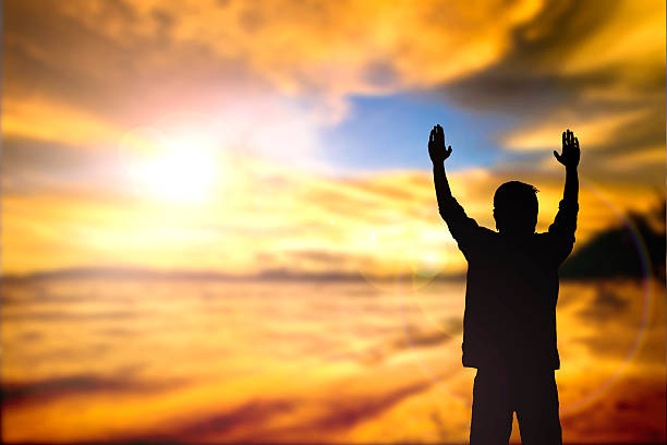 istock Silhouette of man with raised hands 477584458