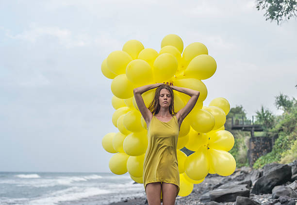 istock girl with yellow balloons 477584543