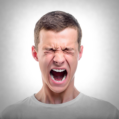 Portrait of young angry man.  Toned photo.