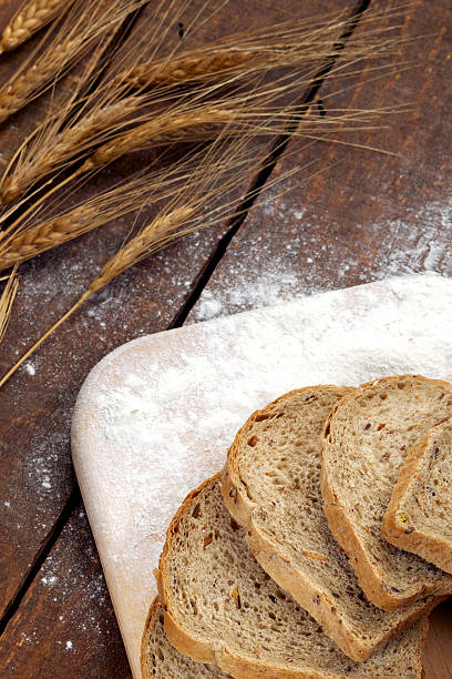 istock Rustic bread and wheat on an old vintage wood table 477587696