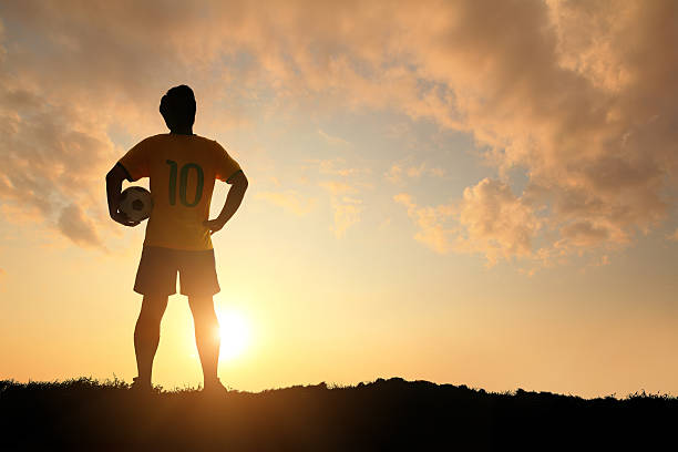 istock Man and soccer silhouette 477591127