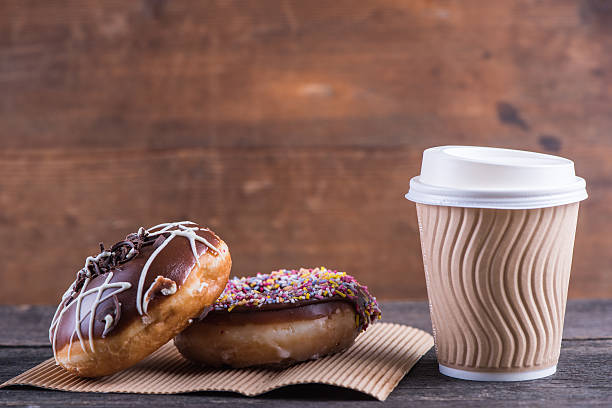 istock fresh artisan donuts and take away coffee, wooden background 477592248