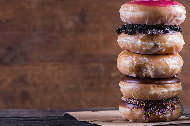 istock Stack of artisan donuts with wooden background,copy space 477592258