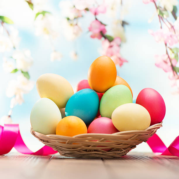 istock Colorful easter eggs and spring flowers on nature background 477593937