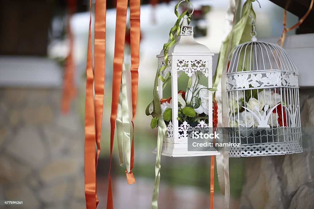 Birdcages decorated with flowers inside, at celebration Anniversary Stock Photo