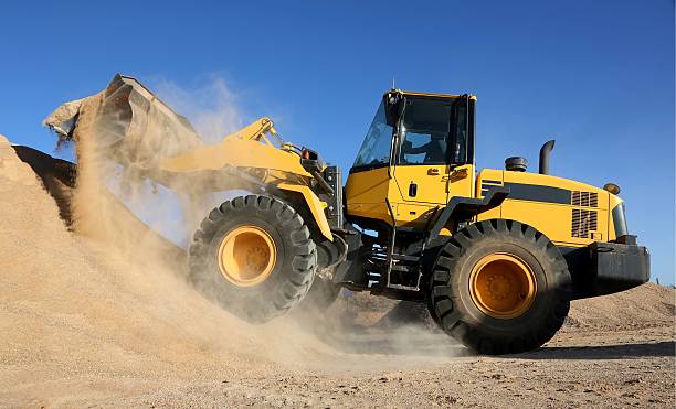 Front End Loading Digging in Sand stock photo