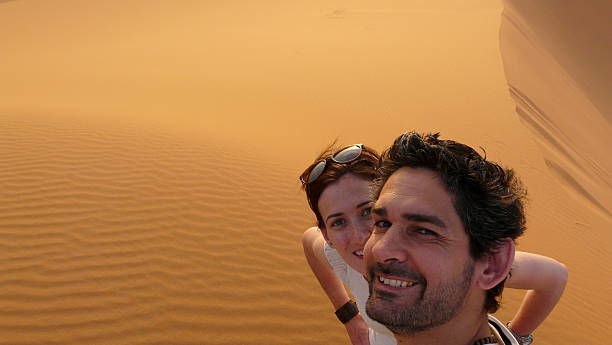 istock Young couple taking a self picture in the desert 477594646