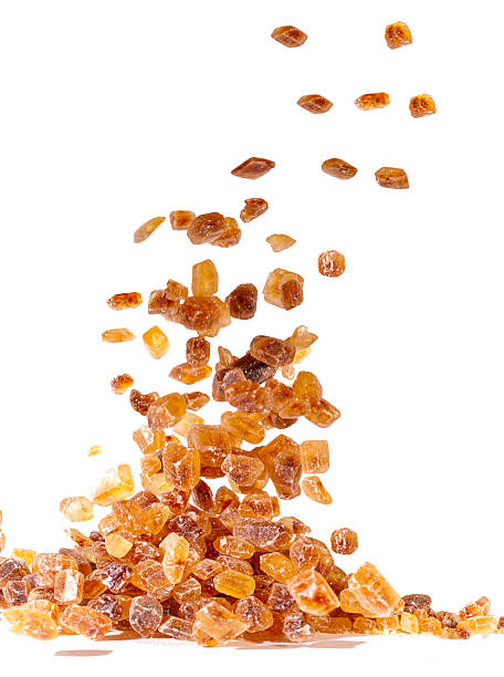 istock Slices of falling brown candy sugar 477595532