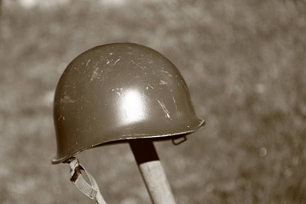 istock Retro NATO or US Army helmet put on spade 477595739