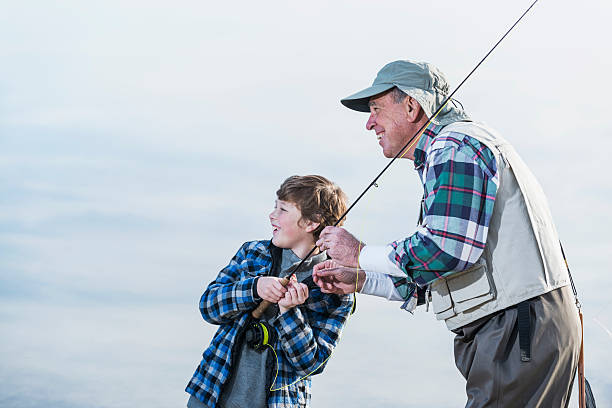 istock Boy fishing with grandfather 477596127