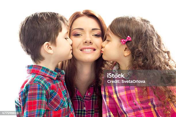 Happy Mother Kissed By Her Daughter And Son Stock Photo - Download Image Now - Adult, Affectionate, Beautiful People