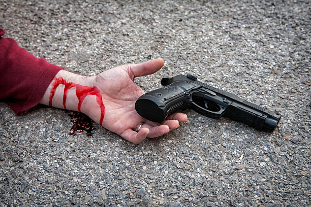 istock man's hand lying on the floor after suicide 477599293