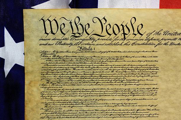 istock American Constitution and US Flag 477599383