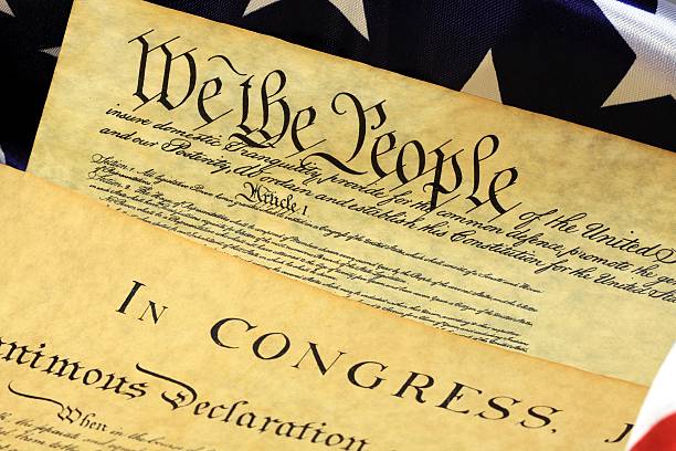 istock American Constitution and US Flag 477599475