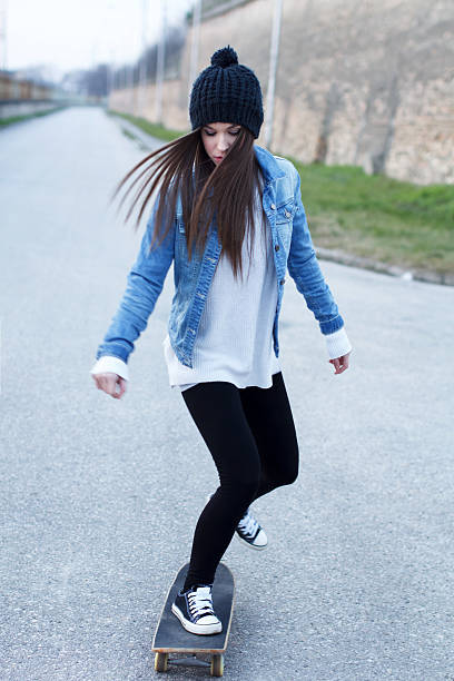istock Young brunette skateboarder girl practice 477599581