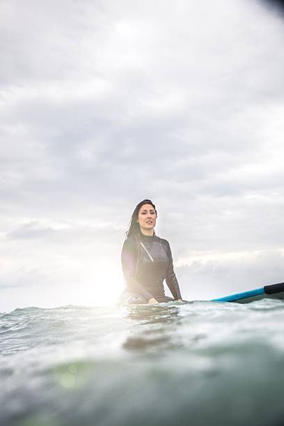 istock Woman surfing in the ocean 477602072