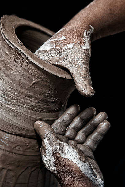 Man's hands making terra-cotta.