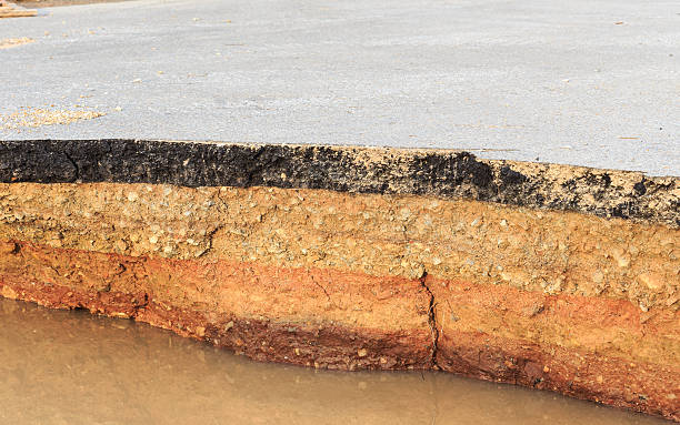 istock Damaged asphalt. Layer of clay that were eroded 477603264