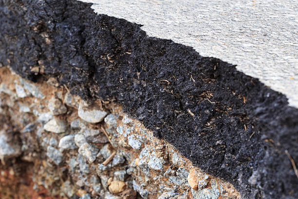 istock Damaged asphalt. Layer of clay that were eroded 477603854