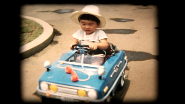 60's 8mm footage - Boy playing with a toy car