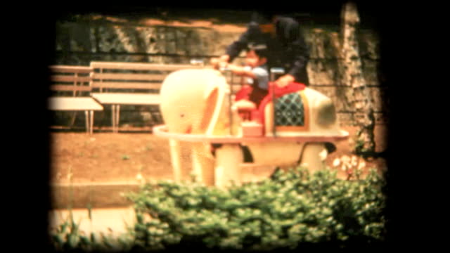 60's 8mm footage - Boy riding on Vehicle elephant