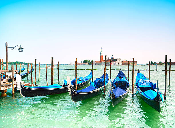 istock Venice sunset, gondolas or gondole and church on background. Ita 477606071