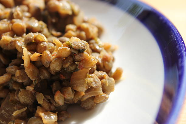 istock Green Brown Lentils Close Up on White Plate 477606419