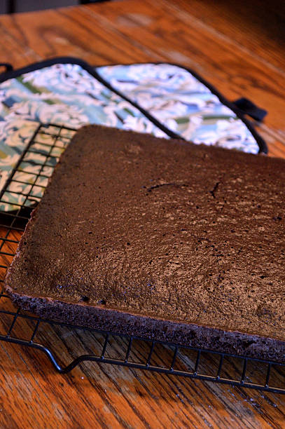 istock Chocolate cake cooling on rack on wooden table 477607516