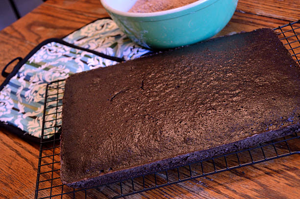istock Dark chocolate cake cooling on rack on wooden table 477607520
