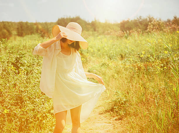 istock Happy woman walking in summer park 477607996
