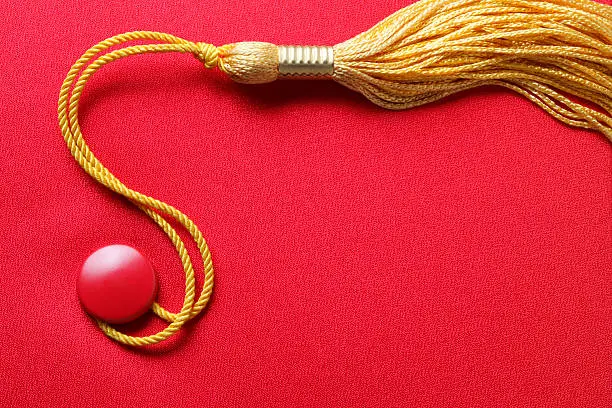 Photo of Red Graduation Cap With Gold Tassel