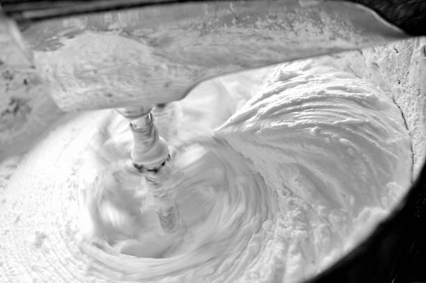 Black and white- whipping homemade vanilla icing in stand mixer