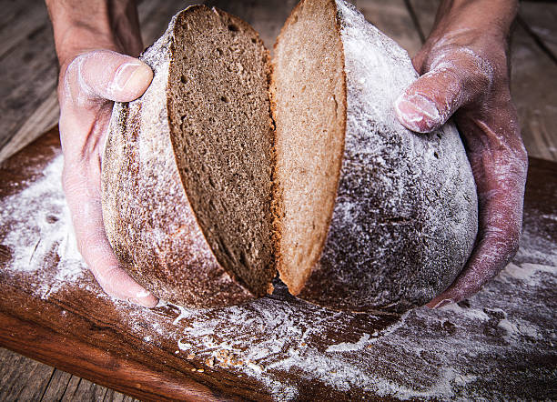istock food. rye bread in male hands 477614276