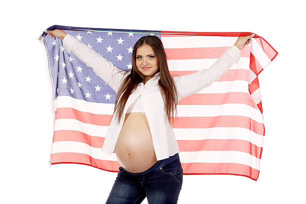 istock Pregnant woman with american flag 477615799