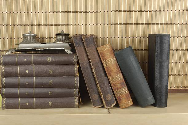 istock Front view of old books stacked on a shelf. 477622830