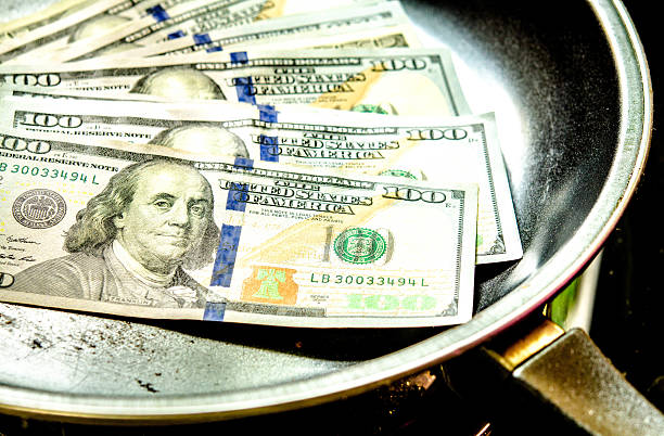 Stack of one hundred dollar bill on pan. stock photo