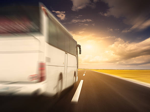 istock White bus in fast driving on an empty asphalt road 477623466
